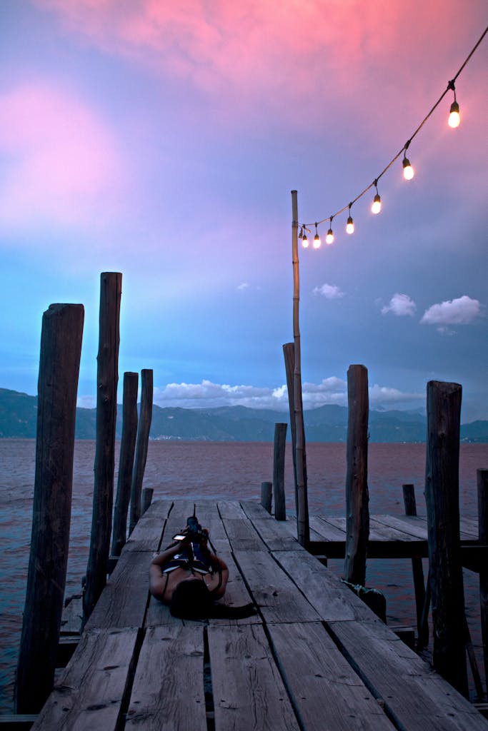 Serene sunset with illuminated pier at Santiago Atitlán, Guatemala.